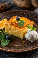 Traditional cake with orange and ice cream.
