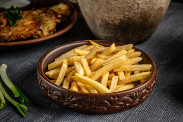 Crispy french fries in a rustic bowl.