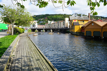 Peaceful riverside walkway in a small scandinavian town.