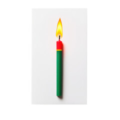 Single burning candle in red yellow and green on white background