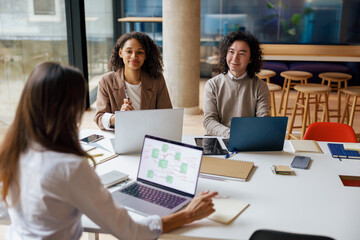 A diverse group of professionals engaging in collaborative discussions and idea generation in a modern office setting