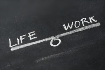 Fototapeta premium Work-life balance concept: seesaw with the words life and work written on it.