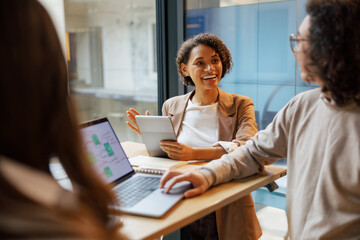 A casual yet professional meeting among colleagues in a chic and stylish office environment that encourages creativity
