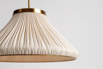 Close-up of a cream-colored pleated pendant lamp with a brass-colored metal trim