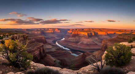 Majestic Canyon at Sunset: Captivating panoramic view of a vast canyon at sunset, displaying layers of geological formations, where the warm colors of the setting sun paint the landscape
