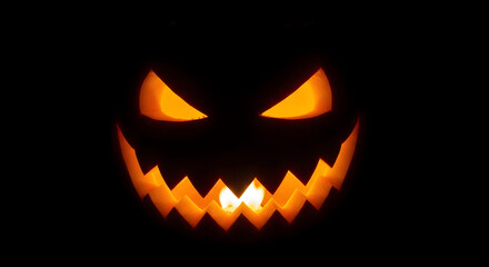Fototapeta premium Glowing Halloween Jack-o’-Lantern Face in Darkness.