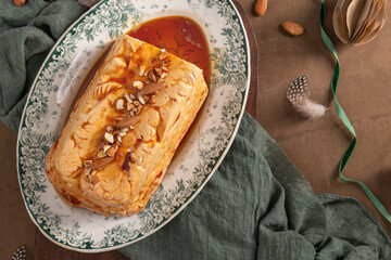 A top-down shot showcases a whole traditional caramelized egg white pudding known as molotof or...
