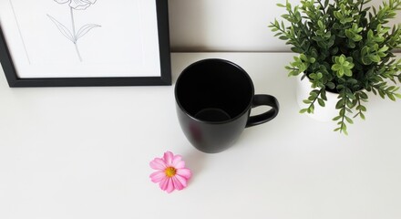 Minimalist Desk Setup with Black Mug Pink Flower and Green Plant.