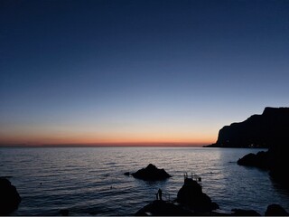 blue sky clouds sea sun sunset rocks ship
