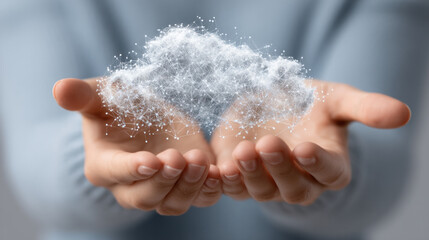 Fototapeta premium Close-up of cupped hands releasing a cloud of powdery snow, creating a delicate, sparkling texture with bright light and a soft, blurred background, evoking wonder.