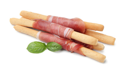 Delicious grissini sticks with prosciutto and basil isolated on white