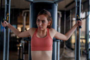 Woman engages in focused workout at gym, showcasing her dedication to fitness and self care. This exercise promotes wellness and highlights importance of maintaining healthy lifestyle