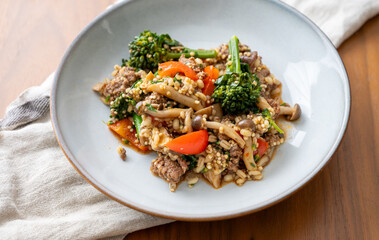 Close up of Healthy One Pot Meal of Ground Bison, Mushrooms, Broccoli, Barley, and Quinoa with Fresh Herbs