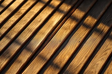 Close-up of wooden planks with smooth polished surface and warm natural tones illuminated by sunlight casting striped shadows