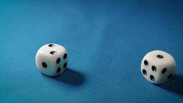 Dice rolling on a blue table, multiple dice fall onto the surface