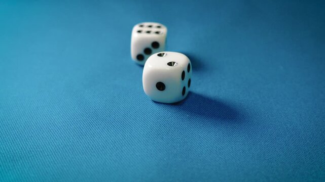 Dice rolling on a blue table, multiple dice fall onto the surface