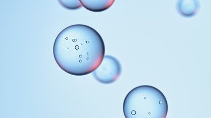 3D render of transparent blue liquid bubbles on soft gradient background.