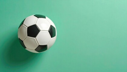 Obraz premium Black and White Soccer Ball on Turquoise Background
