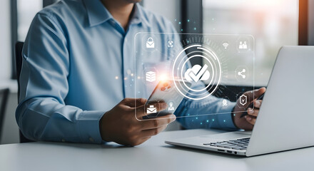 Businessman using futuristic digital interface on tablet with laptop in modern office environment for technology innovation and cybersecurity concepts