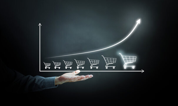 E-commerce growth concept with shopping cart graph and rising sales chart, symbolizing online business success, digital marketing strategy, and increasing consumer demand.