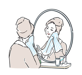 鏡の前に立つバスローブ姿の女性　洗顔