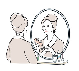 鏡の前に立つバスローブ姿の女性　スキンケア