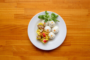 Dim Sum Delight: An overhead perspective showcases an array of dim sum delicacies beautifully presented on a pristine plate, a tempting culinary composition.