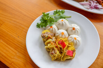 Delightful Dim Sum: A tempting plate of assorted dim sum showcases a culinary delight, featuring steamed buns and flavorful dumplings, capturing the essence of gastronomic pleasure and freshness.