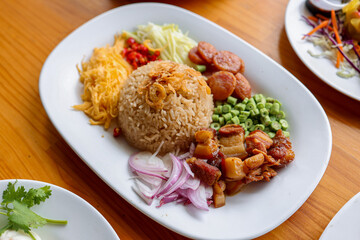 Thai Rice Cuisine: A beautifully arranged plate showcasing an array of authentic Thai culinary delights, from the aromatic rice centerpiece to vibrant side dishes.
