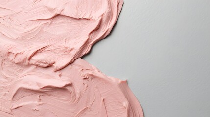 Fototapeta premium Abstract close-up of smooth pastel pink creamy texture spread on gray surface, representing beauty cosmetic background, skincare product, paint art surface, minimalism, and luxury design concept for c