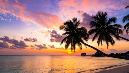 Vibrant sunset over calm ocean, silhouetted palm trees on beach
