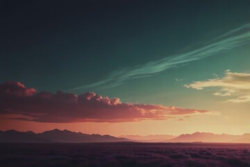 Obraz premium The orange-red evening sunset bathes the majestic mountains and colorful sky in a warm light