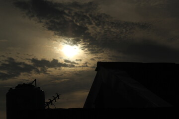 Golden sunset sky, yellow sun at dawn, orange clouds in the night sky above the view of summer...