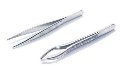 Fototapeta premium A pair of forceps with textured grip, laid flat on bright white background. Modern medical equipment ensures patient safety and improves healthcare quality.