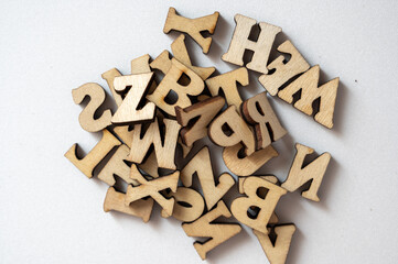 Wooden Alphabet Letters in a Random Pile on a Light Background