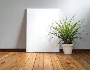 A minimalist interior display featuring a blank canvas, a potted air plant, and a light-toned wooden floor.