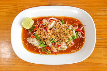 Exquisite Seafood Appetizer: A top-down shot showcasing a vibrant seafood dish, meticulously presented on a crisp white plate, embodying culinary artistry and enticing gastronomic delight.