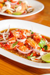 Seafood Culinary Delight: A close-up of a visually appealing seafood dish, featuring vibrant shrimp, fresh vegetables, and zesty seasoning.