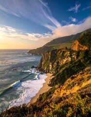 Dramatic coastal vista showcasing a secluded beach nestled beneath towering cliffs at sunset.