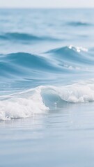Obraz premium Gentle ocean waves rolling onto a calm shoreline with soft white foam