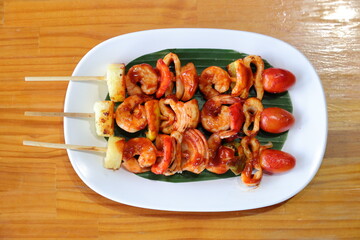 Grilled Skewers: A mouthwatering display of grilled skewers, artfully arranged on a white plate, inviting a delightful culinary experience.