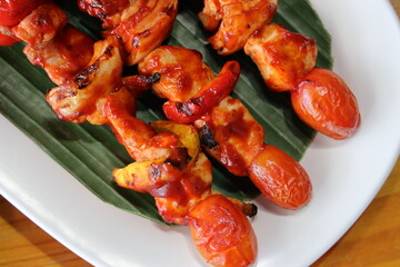 Grilled Chicken Skewers: A mouthwatering photograph showcasing grilled chicken skewers on a plate, complemented by fresh ingredients and expert culinary presentation.