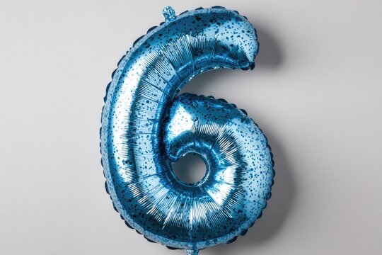 A light blue number six foil balloon against a white background