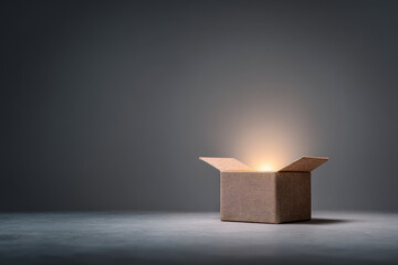 beautifully wrapped open gift box with soft warm light glowing from within creating inviting atmosphere