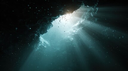 Sunlight filters through the entrance of an underwater cave, casting ethereal beams of light into the dark depths below
