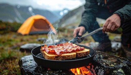 Bacon sandwiches cooking over campfire in mountains