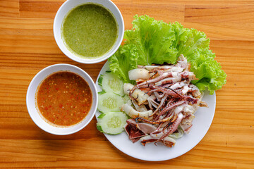 Grilled Squid Delight: A culinary masterpiece showcasing the artistry of grilling, with tender...