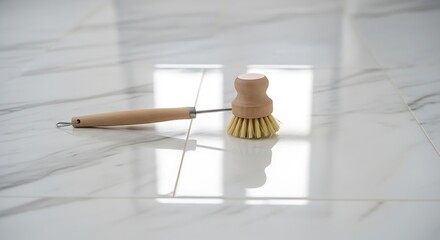 Wooden Dish Brush Resting on Gleaming Marble Tiled Kitchen Surface