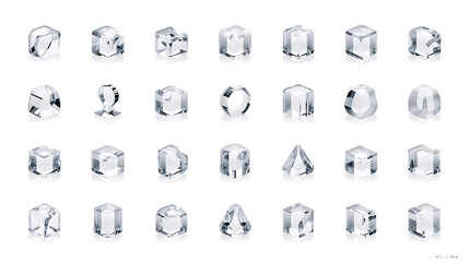 Twenty four glossy geometric shapes with sharp edges reflect light arranged on a reflective surface