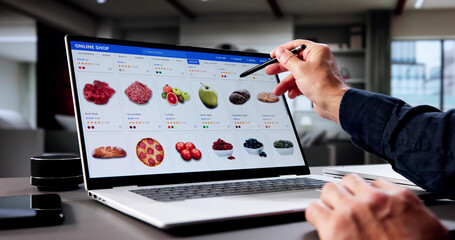 Older Man Browsing Vegetable Delivery Service On Laptop